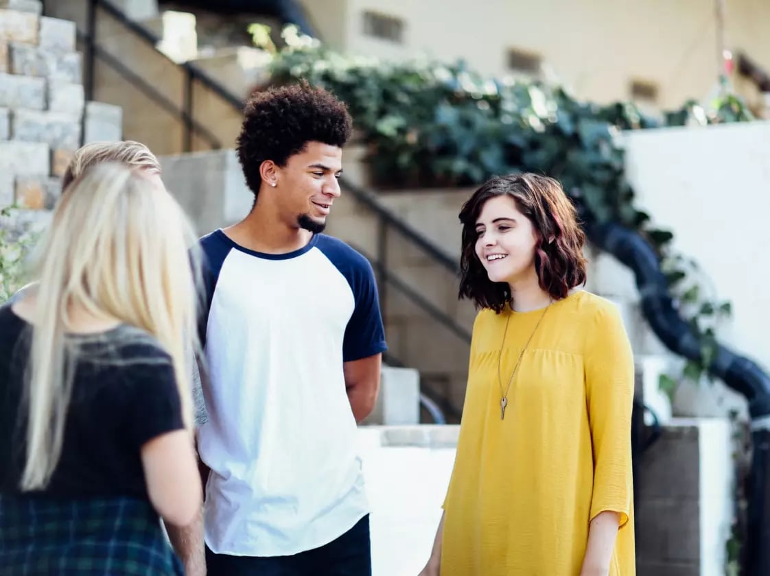 Group of young colleagues socialising during an internship for graphic design students