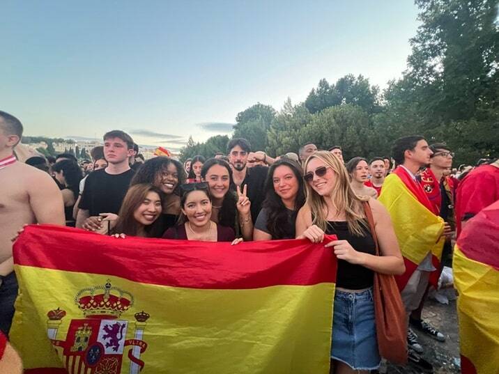 Interns enjoying their time in Madrid, Spain. They are holding the Spanish flag.