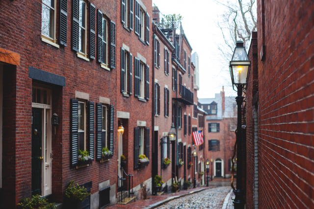 A cobbled street lined with brick buildings