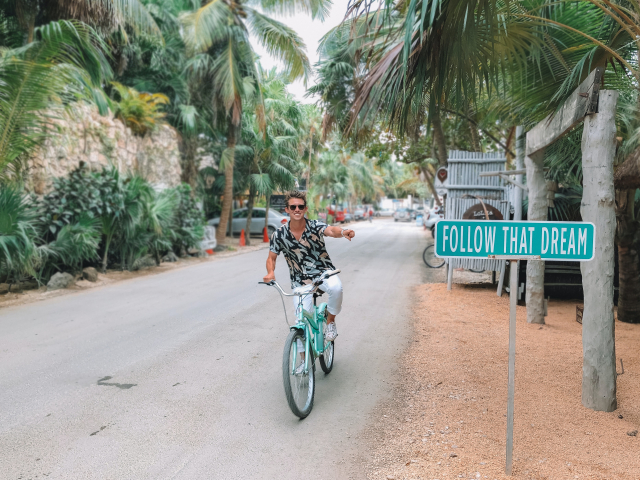 Digital Nomad on a bike in Mexico (Entrepreneur Austin Distel bicycles in Tulum, Mexico, by Austin Distel on Unsplash.)