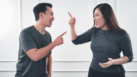 Two work colleagues arguing during a workplace conflict.