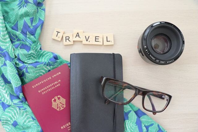 Preparing for travel with a passport and camera.