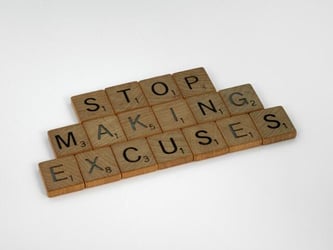 Scrabble tiles that say 'stop making excuses'