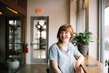 A young professional smiling and being happy at work during their internship abroad.