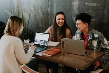 Three young professionals with excellent interpersonal skills working together as a team.