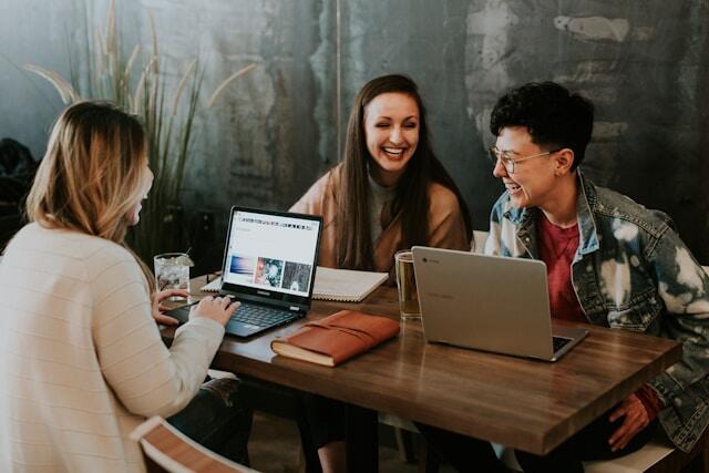 Three young professionals with excellent interpersonal skills working together as a team.