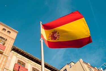 The Spanish flag billowing on a sunny day in Madrid.