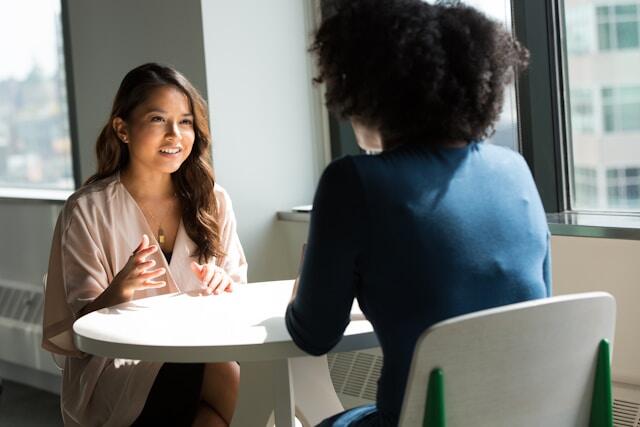 Young professionals using their interpersonal skills to talk at work.