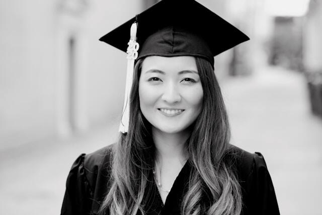 A young woman in a graduation cap after graduating with a liberal arts degree.