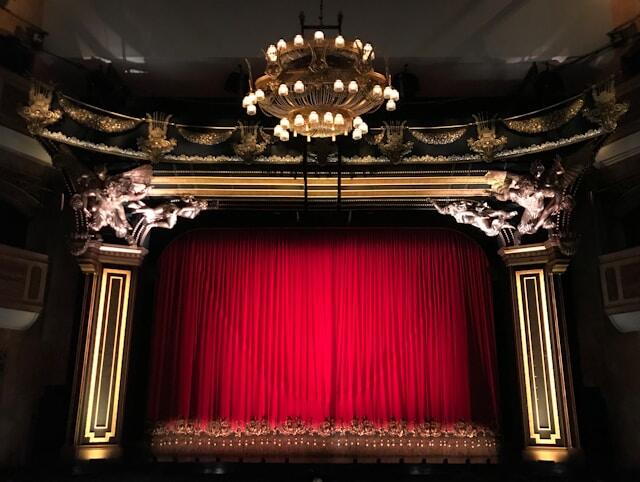 A thick red curtain on a stage at a theater internship in London.