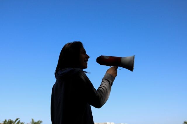 Shouting through a megaphone to increase brand awareness.