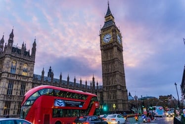 A red London bus in front of Big Ben.