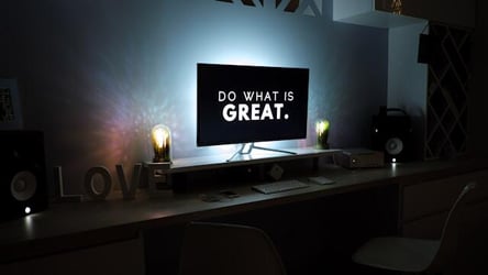 A computer with a screensaver that says 'Do what is great.'