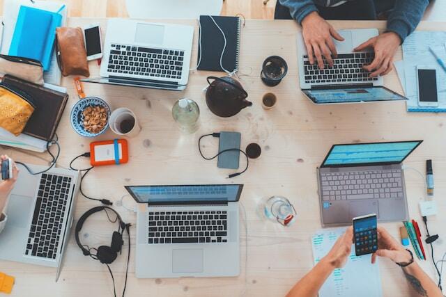 An assortment of technology being used by Gen Z including laptops, phones, and tablets.