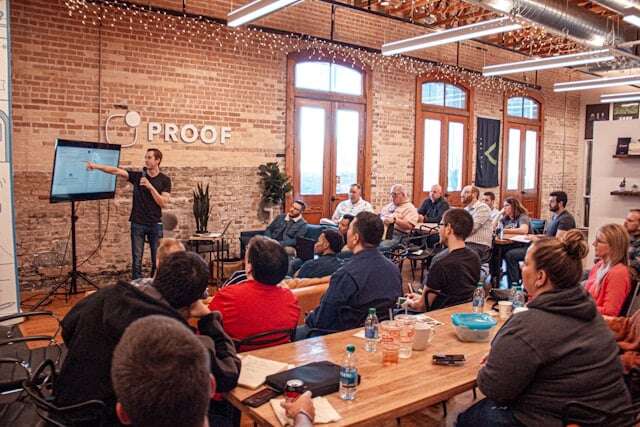 A man giving a presentation during his internship.