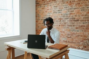 A young man working in business works online.