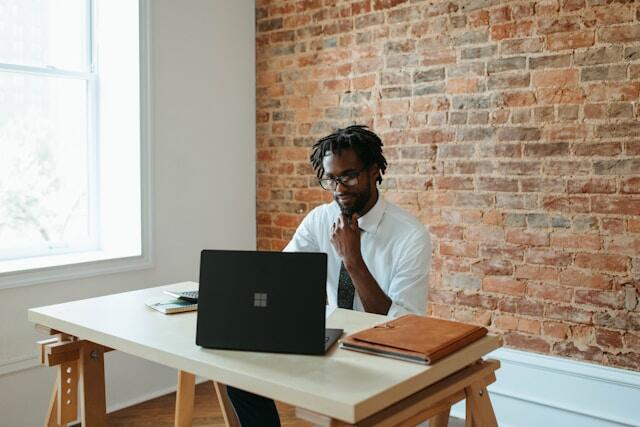 A smartly dressed man working at a laptop during an engineering internship in New York