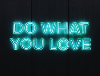 A blue neon sign that says 'Do what you love.'