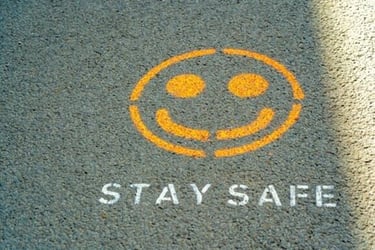 A sign on a road that reads 'stay safe'