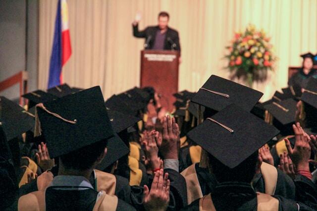 Graduates listening to an inspiring graduation speech.