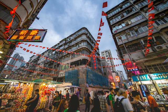 People walking through a street in Hong Kong.