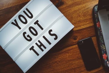 A sign on a desk reading 'you got this', encouraging motivation and productivity.