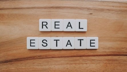 Scrabble tiles spelling out 'real estate'
