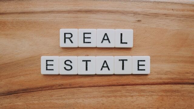 Scrabble tiles spelling out 'real estate'