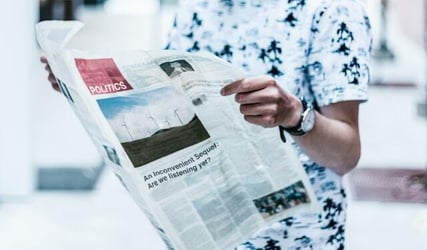 A man reads a political newspaper.