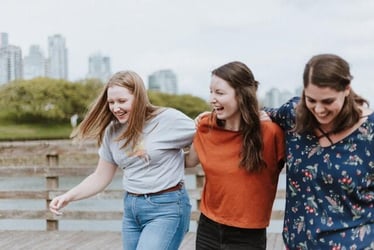 Three friends laugh together during their internship abroad