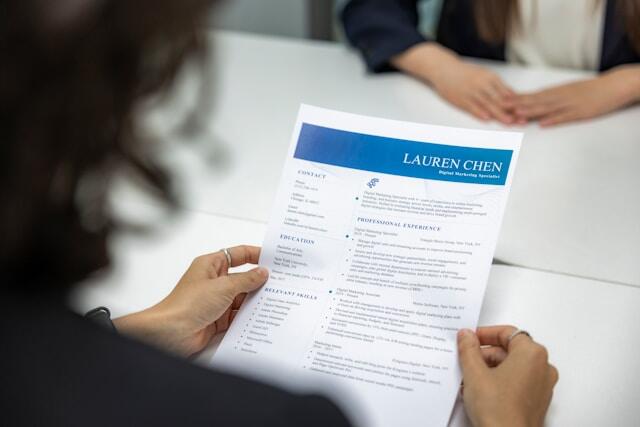 An interviewer looks over a CV during a job interview.