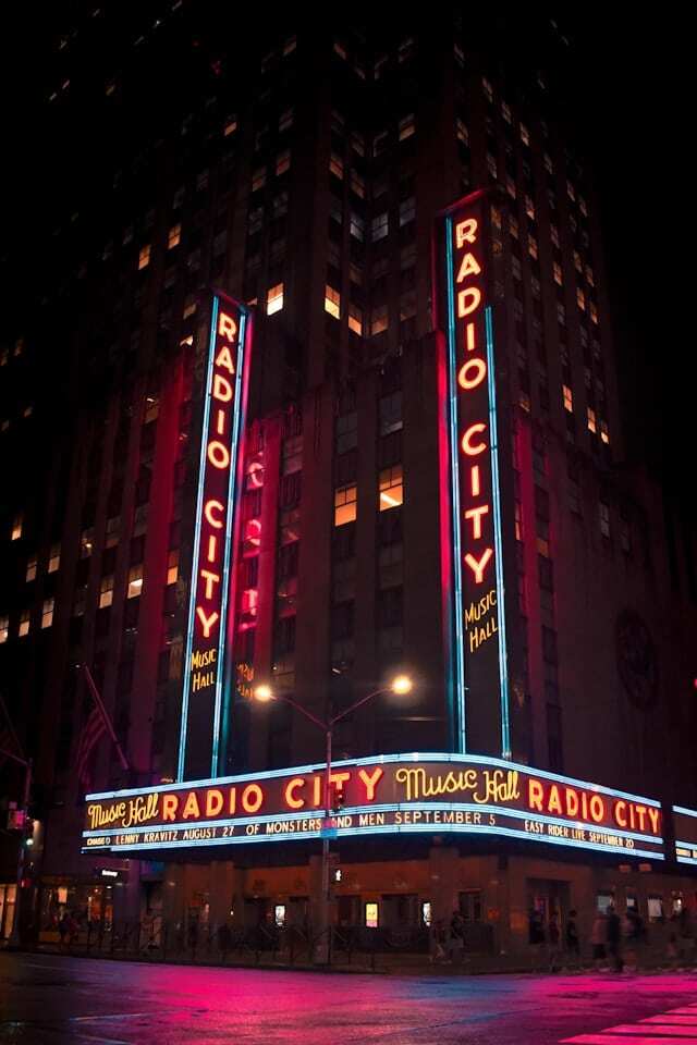 Radio City Music Hall lit up from the outside at night in New York.
