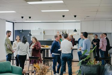 A group of coworkers gathered together and socializing outside of work.