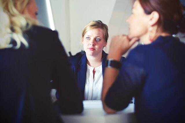 Two interviewers listen to an answer to their interview question.