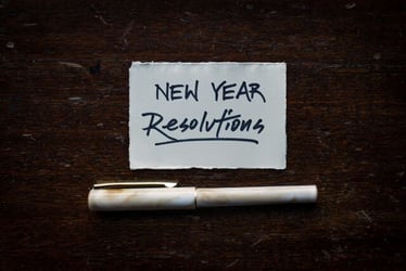 Writing new year's resolutions that include traveling for an internship abroad.