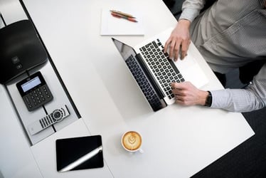 A business major doing a business internship abroad, working with a laptop and notebook.