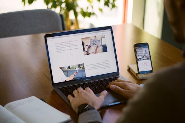 A man working on a laptop, building a website.