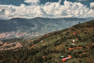 The suburbs of Medellin, Colombia, with view of lush green hills and mountains.