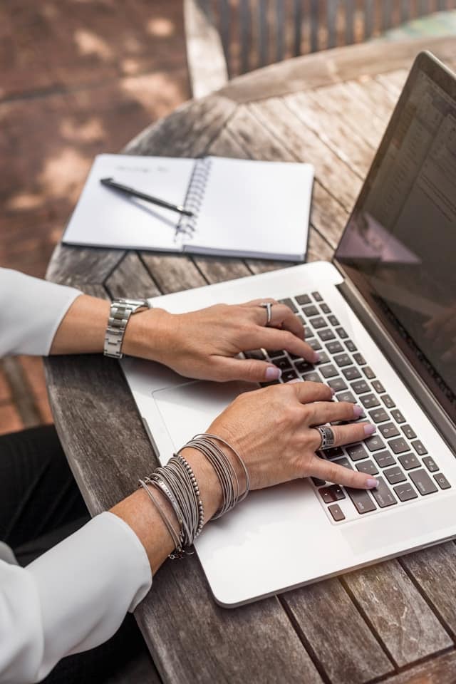 Hands poised over a laptop as a young professional updated their LinkedIn profile.