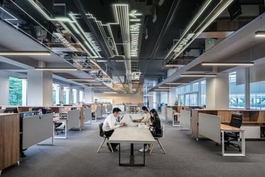 Three people sit in an open-plan office in China.